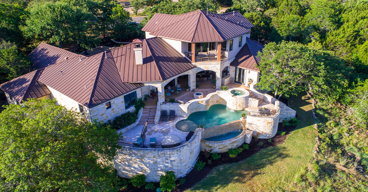 RR Residential Custom mansion home with pool from birdseye view backyard