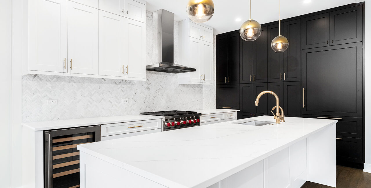 a luxury custom home kitchen with white cabinets and black cabinets